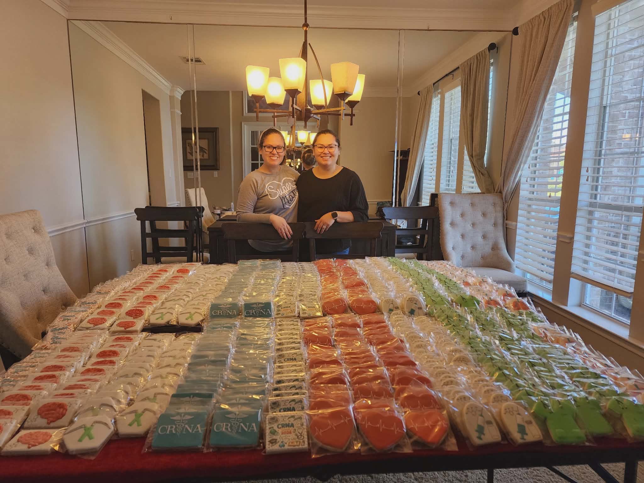Cookie artists behind a large display of finished cookies